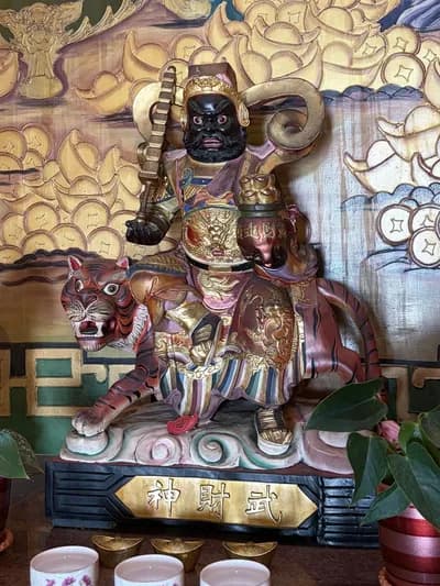 玄壇元帥神像：黑面、手持法器，騎坐猛虎，座前立著「武財神」名牌
